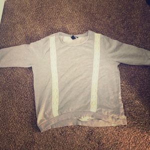 A long sleeve shirt that has lace on the front